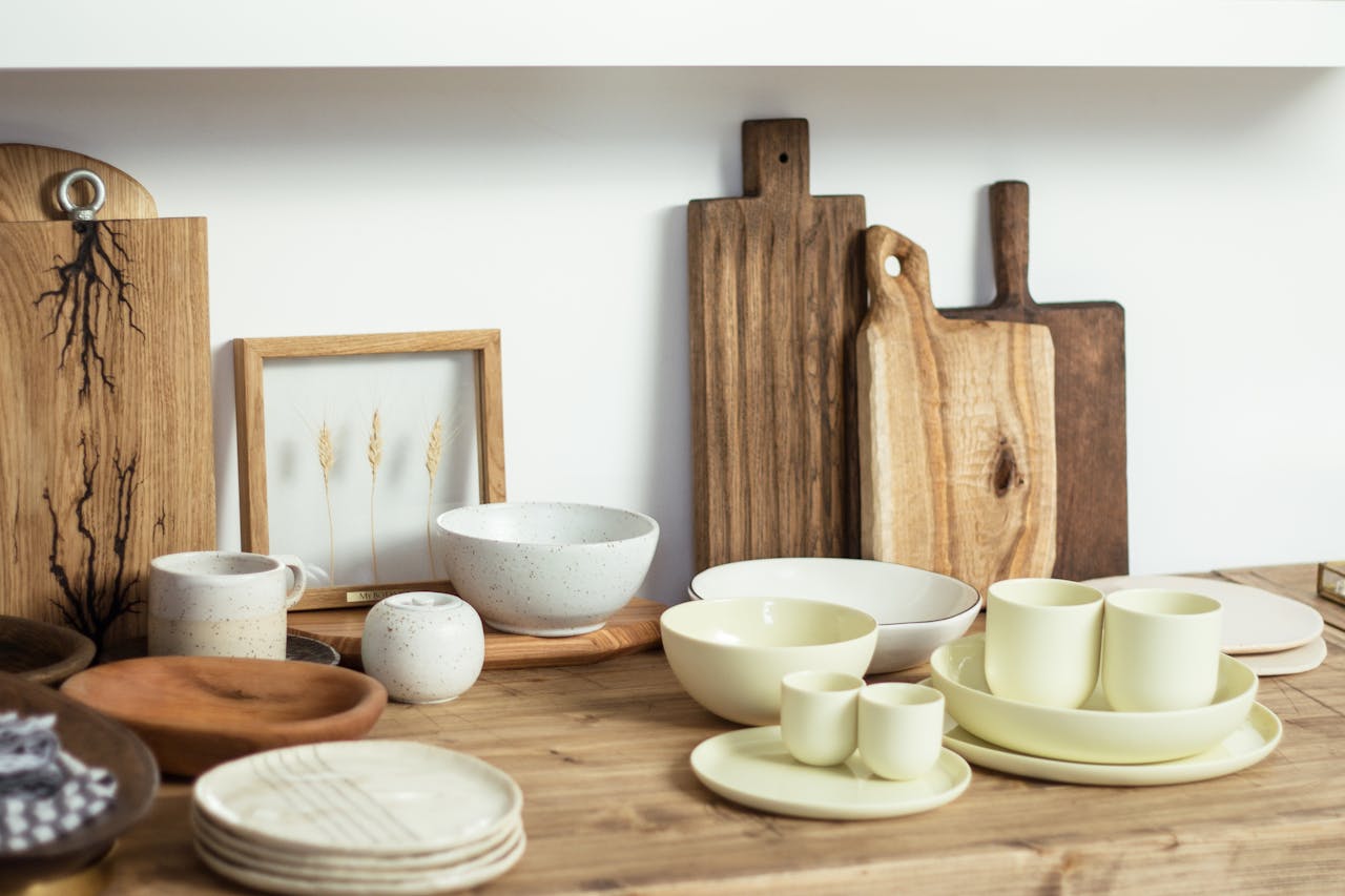gallery-02 Set of minimalist light ceramic dishware and cutting boards arranged on wooden shelf in modern kitchen